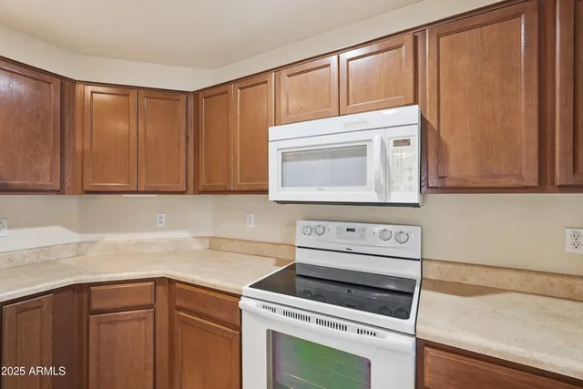 a kitchen with granite countertop cabinets stainless steel appliances and a counter space
