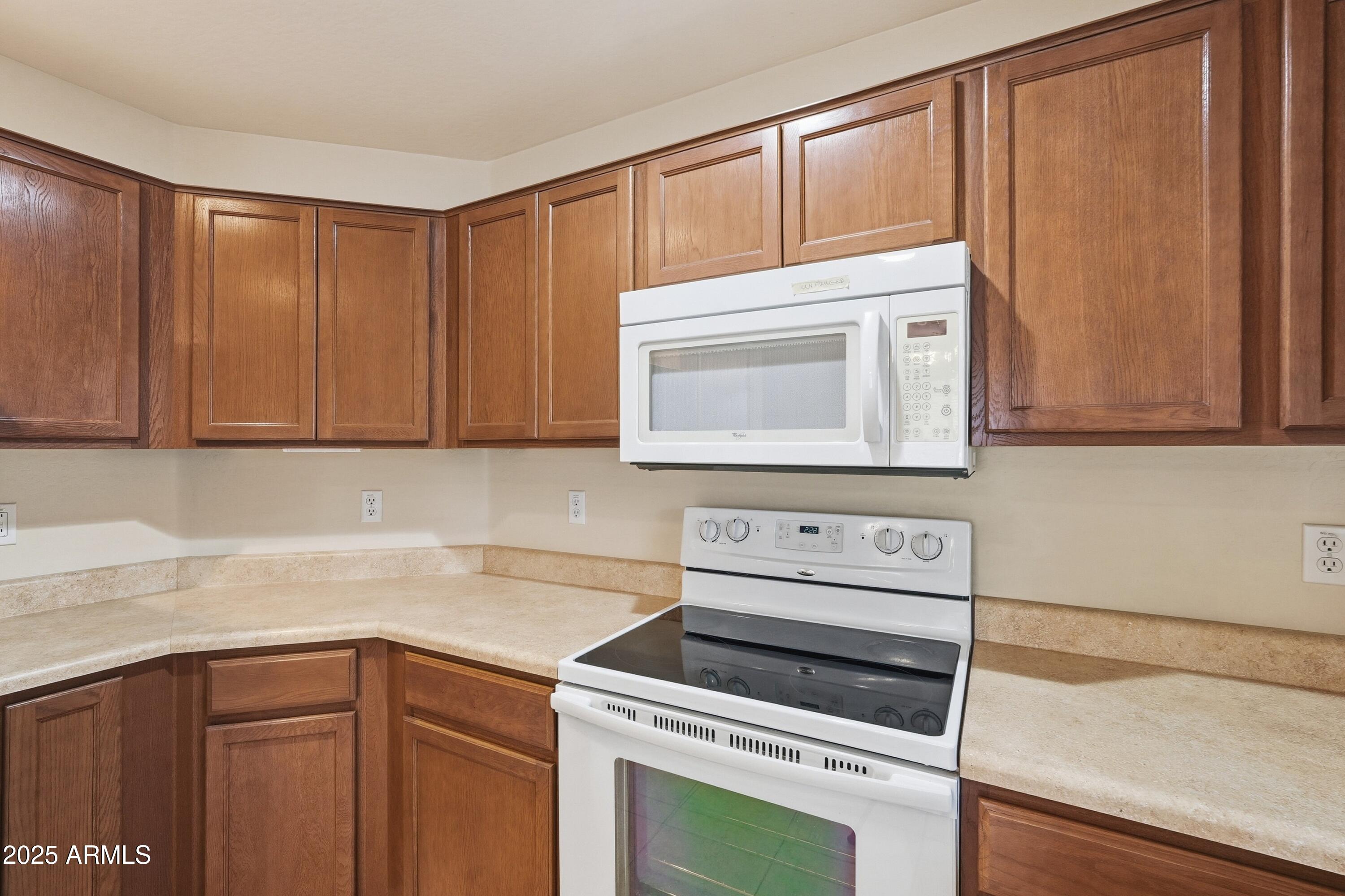 2101 South Meridian Road, Unit 210 Apache Junction, AZ 85120 - Photo 10 of 32 a kitchen with granite countertop cabinets stainless steel appliances and a counter space