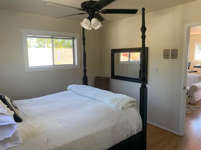 a bedroom with a bed and a chandelier