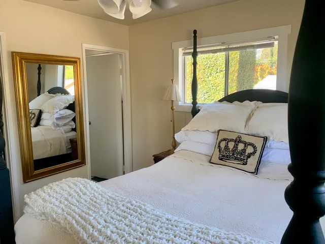 a bedroom with a large bed and a window