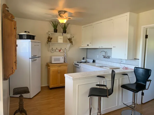 a kitchen with stainless steel appliances a stove a refrigerator and cabinets