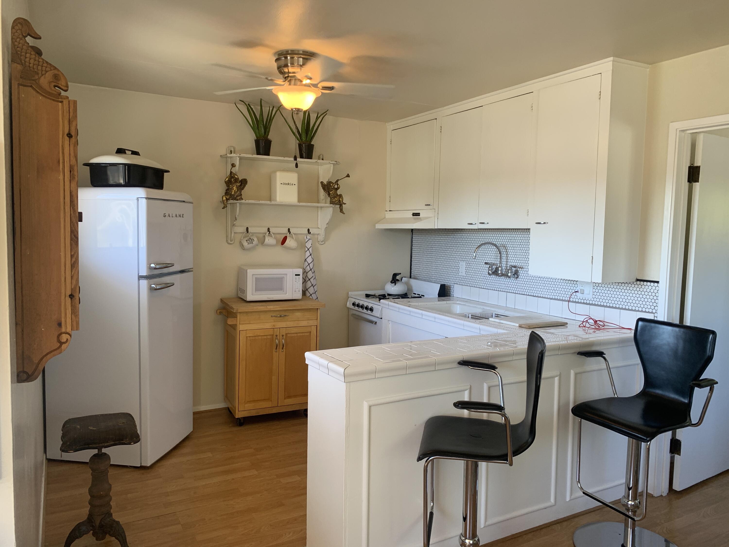 2528 De La Vina Street Santa Barbara, CA 93105 - Photo 29 of 32 a kitchen with stainless steel appliances a stove a refrigerator and cabinets