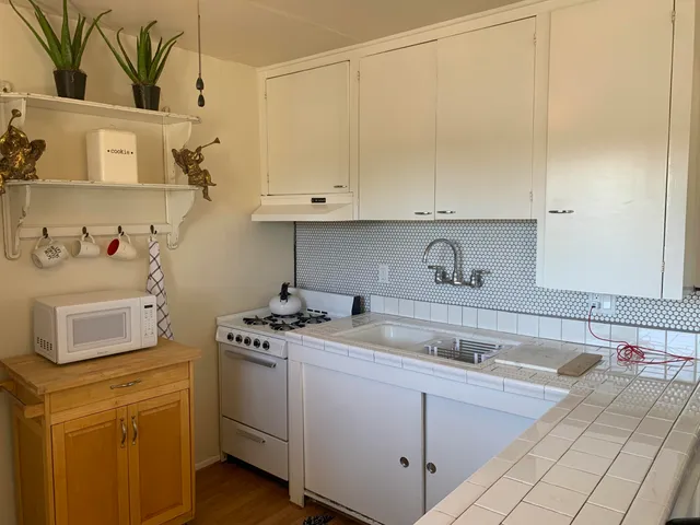 a kitchen with a sink stove and cabinets
