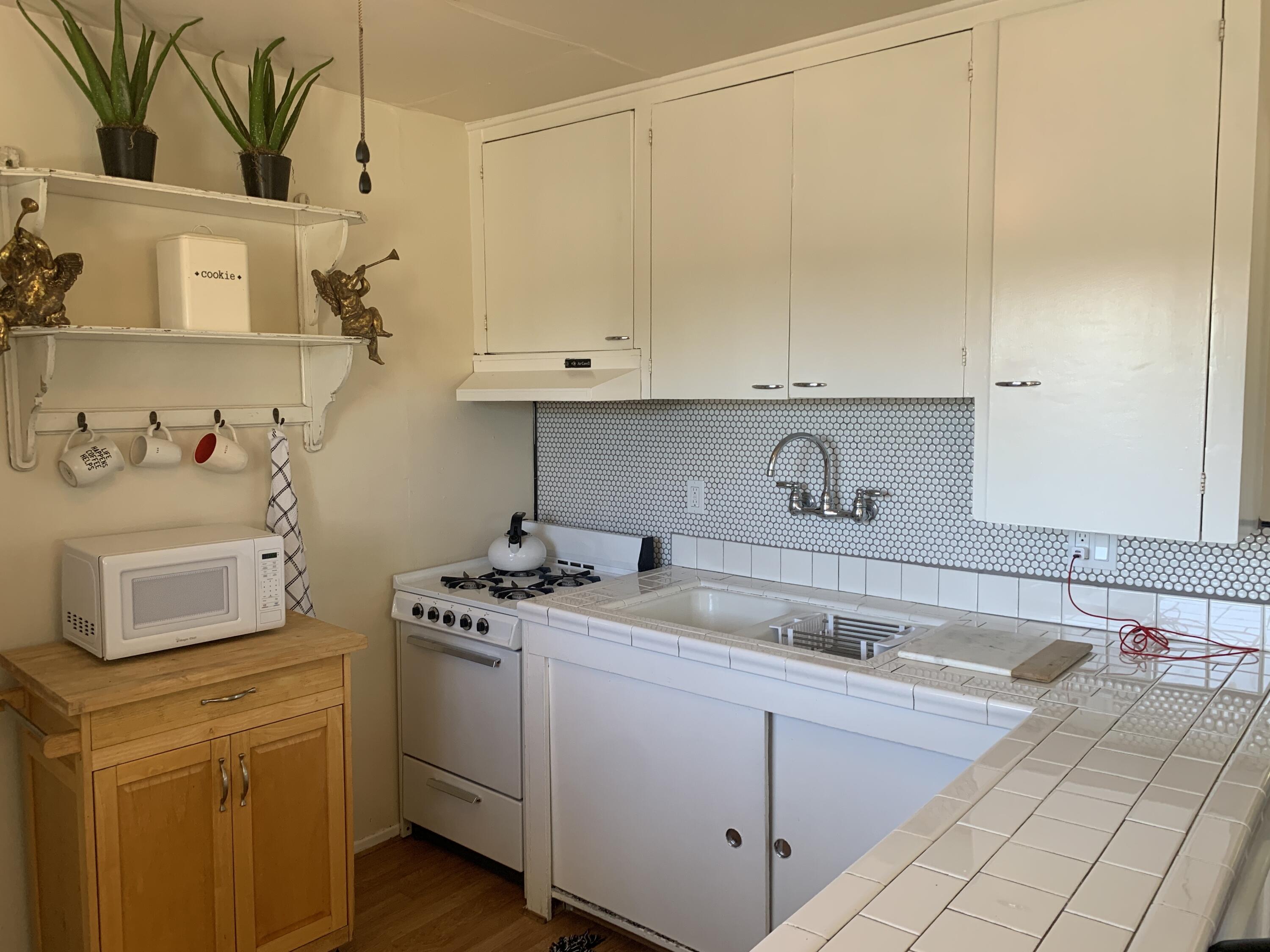 2528 De La Vina Street Santa Barbara, CA 93105 - Photo 31 of 32 a kitchen with a sink stove and cabinets