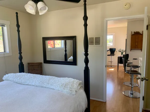 a bedroom with a bed and chandelier
