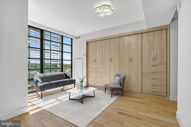 a living room with furniture and a floor to ceiling window