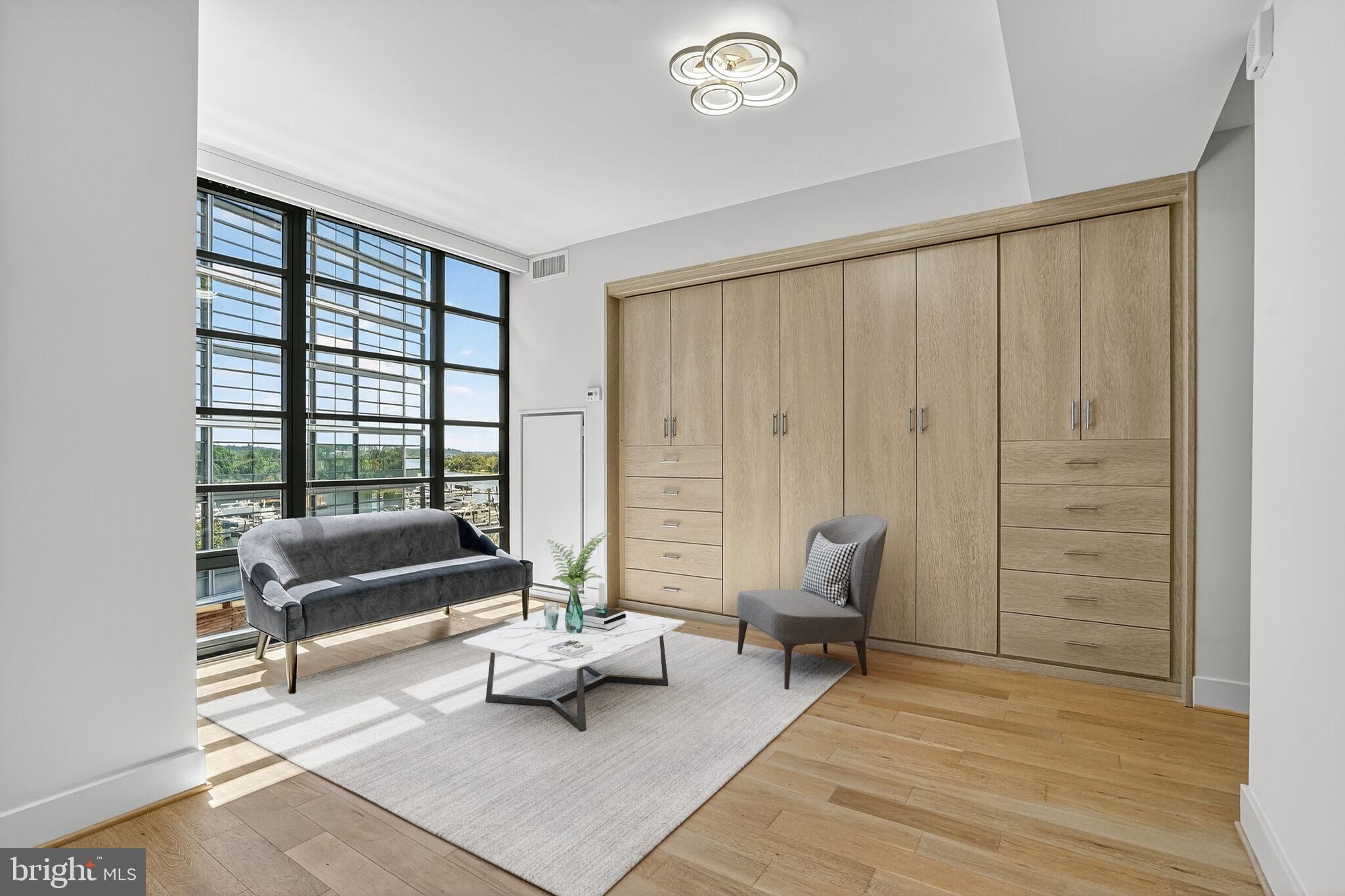 45 Sutton Square Southwest, Unit 509 Washington, DC 20024 - Photo 11 of 25 a living room with furniture and a floor to ceiling window