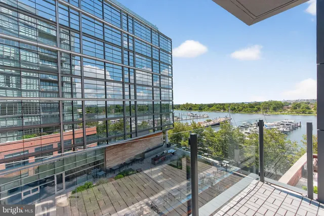 a view of a balcony with floor to ceiling windows with wooden floor
