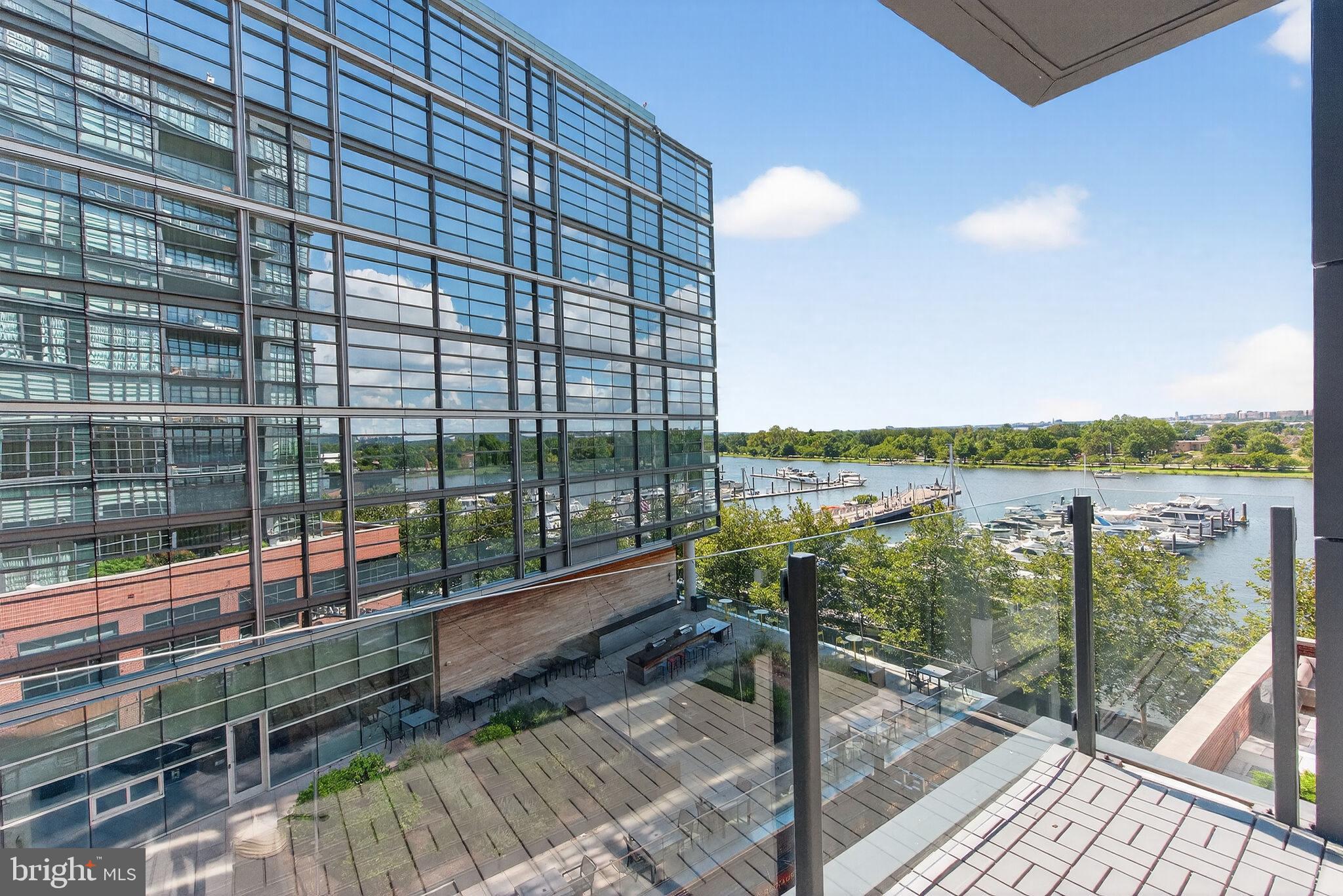 45 Sutton Square Southwest, Unit 509 Washington, DC 20024 - Photo 12 of 25 a view of a balcony with floor to ceiling windows with wooden floor