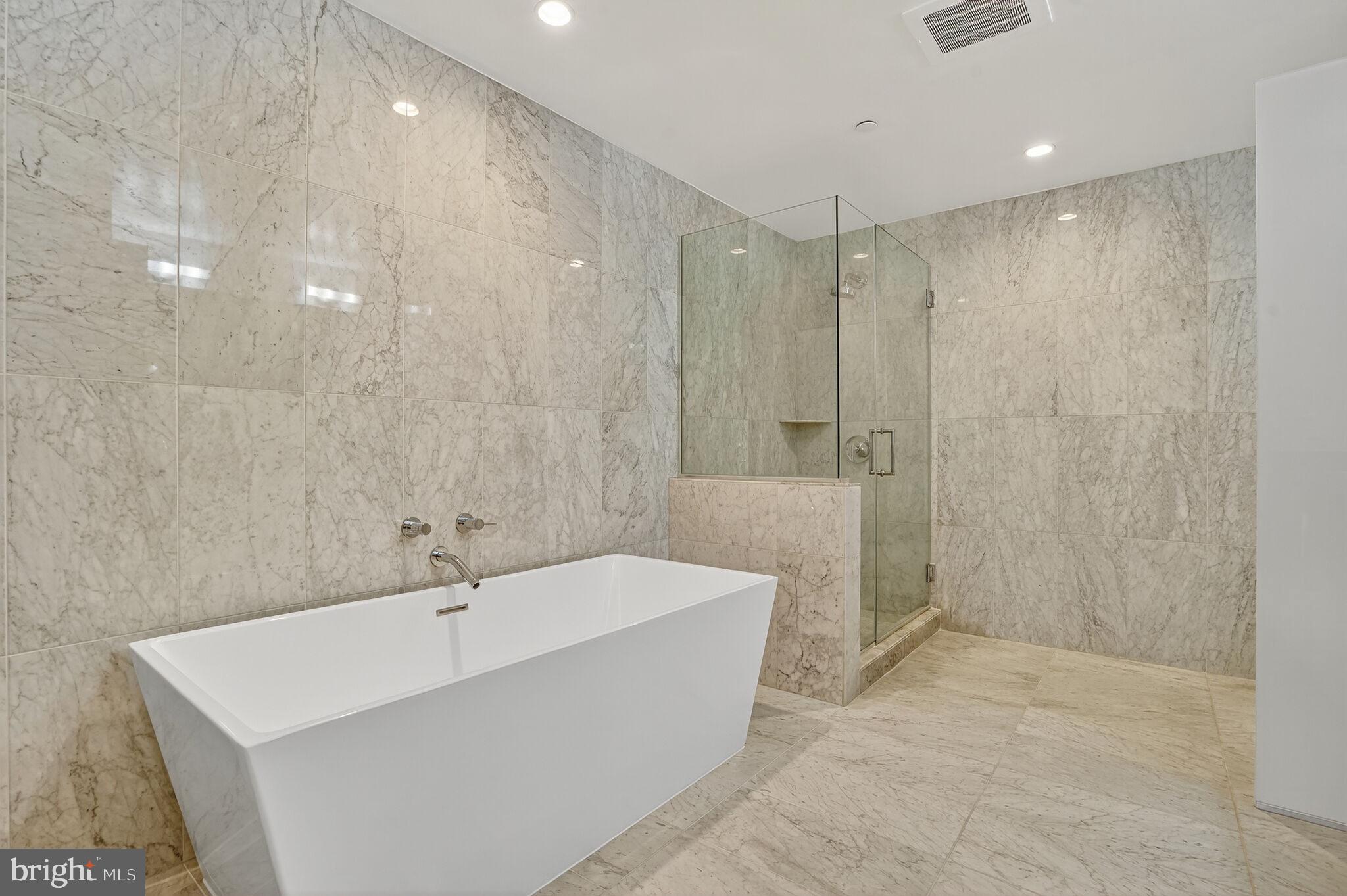 45 Sutton Square Southwest, Unit 509 Washington, DC 20024 - Photo 14 of 25 a bathroom with a bathtub and shower