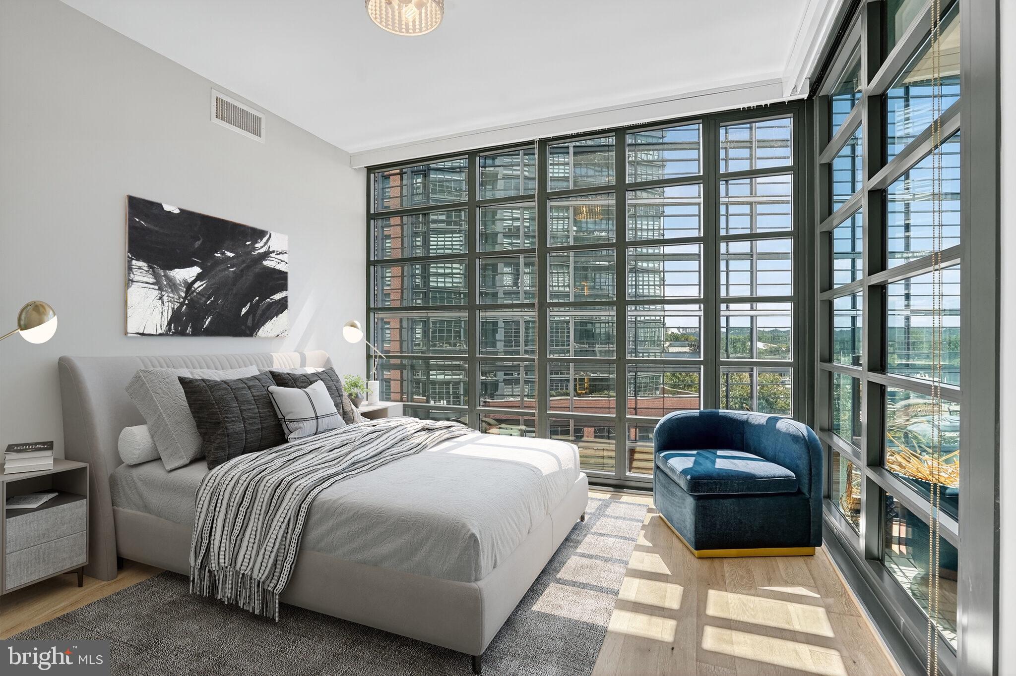 45 Sutton Square Southwest, Unit 509 Washington, DC 20024 - Photo 15 of 25 a bedroom with a bed a couch and a large window