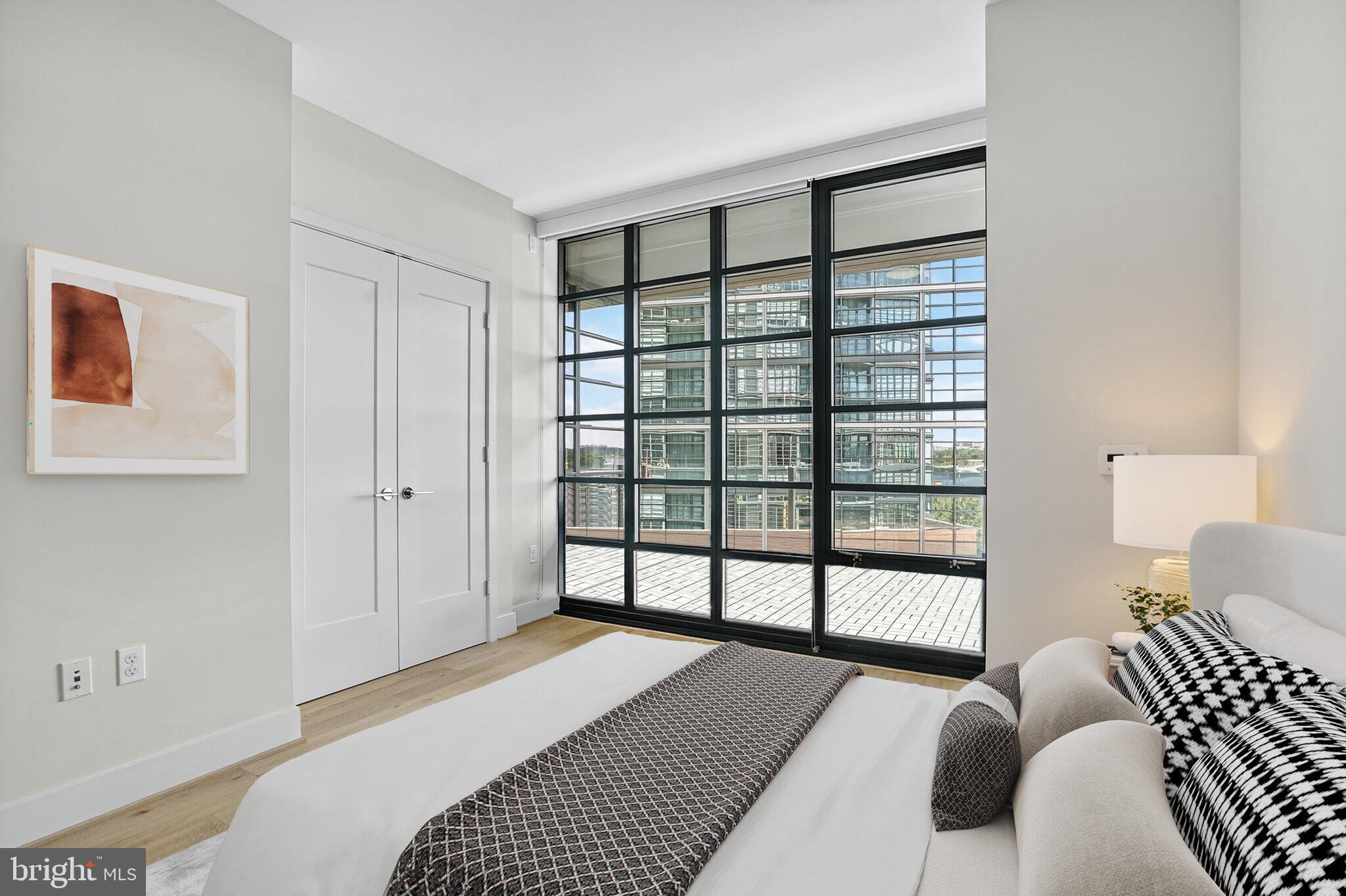 45 Sutton Square Southwest, Unit 509 Washington, DC 20024 - Photo 17 of 25 a bedroom with a bed and a large window