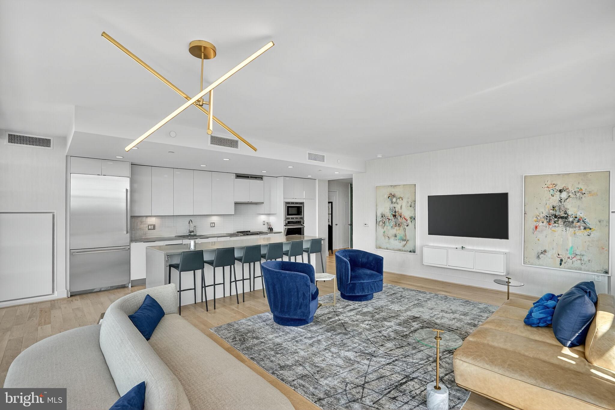 45 Sutton Square Southwest, Unit 509 Washington, DC 20024 - Photo 5 of 25 a living room with furniture and a flat screen tv