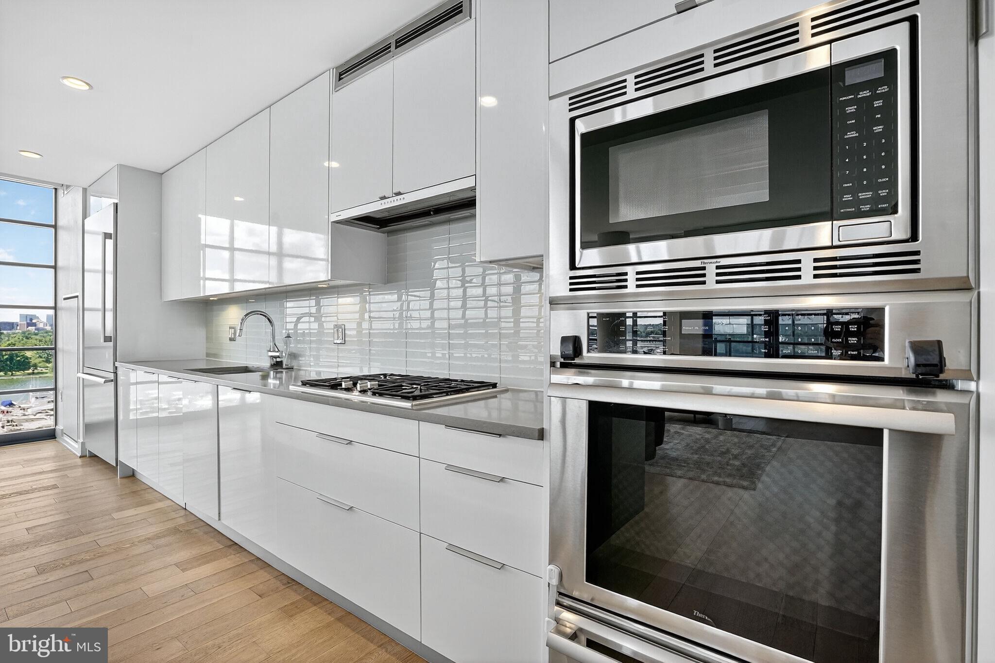 45 Sutton Square Southwest, Unit 509 Washington, DC 20024 - Photo 9 of 25 a kitchen with stainless steel appliances and cabinets