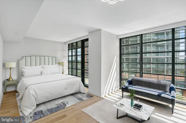 a bedroom with a bed a couch and a window