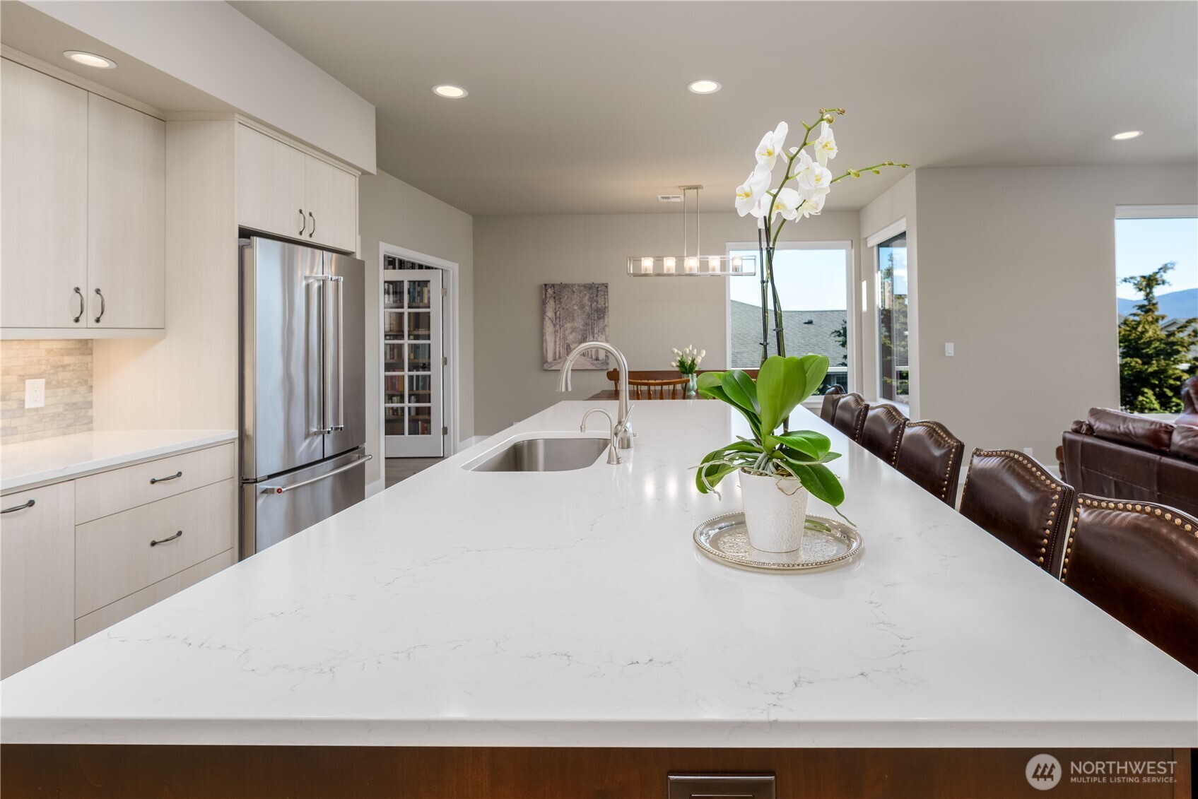 621 Jones Farm Road Sequim, WA 98382 - Photo 15 of 40 a kitchen with stainless steel appliances kitchen island granite countertop a refrigerator a sink dishwasher and white cabinets with wooden floor