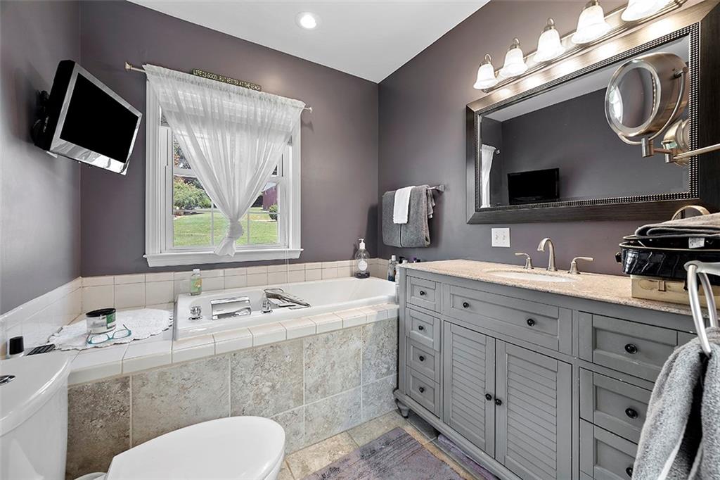 39 Diebold Road McKees Rocks, PA 15136 - Photo 16 of 25 a bathroom with a sink a large mirror and a window