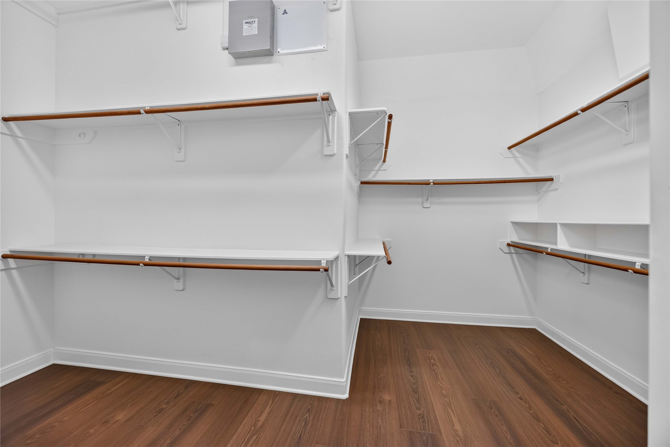3303 Raleigh Row Missouri City, TX 77459 - Photo 30 of 50 Spacious Primary walk-in closet featuring ample shelving and hanging space, complemented by elegant wood flooring.
