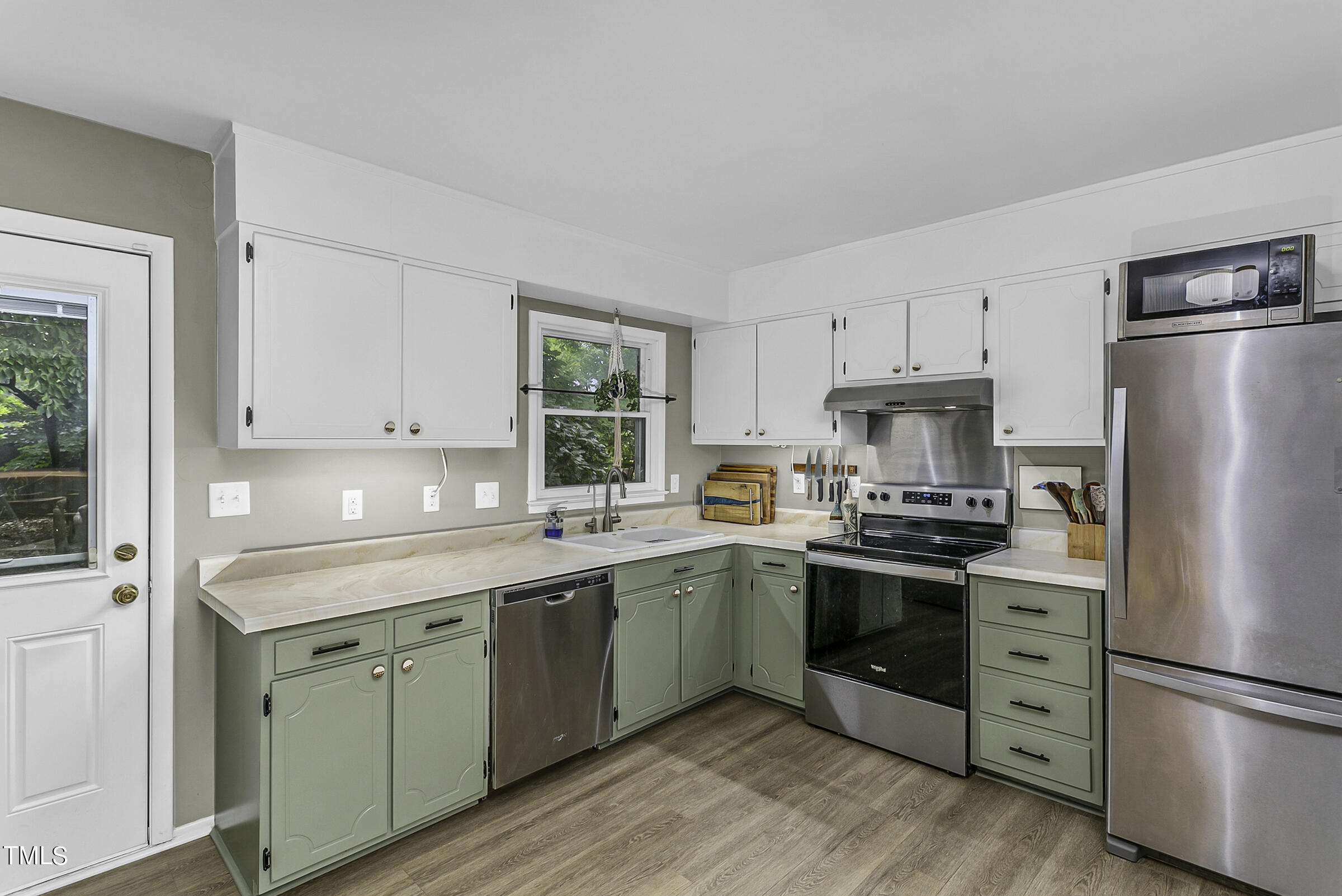 4120 Toroella Street Durham, NC 27704 - Photo 12 of 21 a kitchen with stainless steel appliances a sink a stove a refrigerator and cabinets