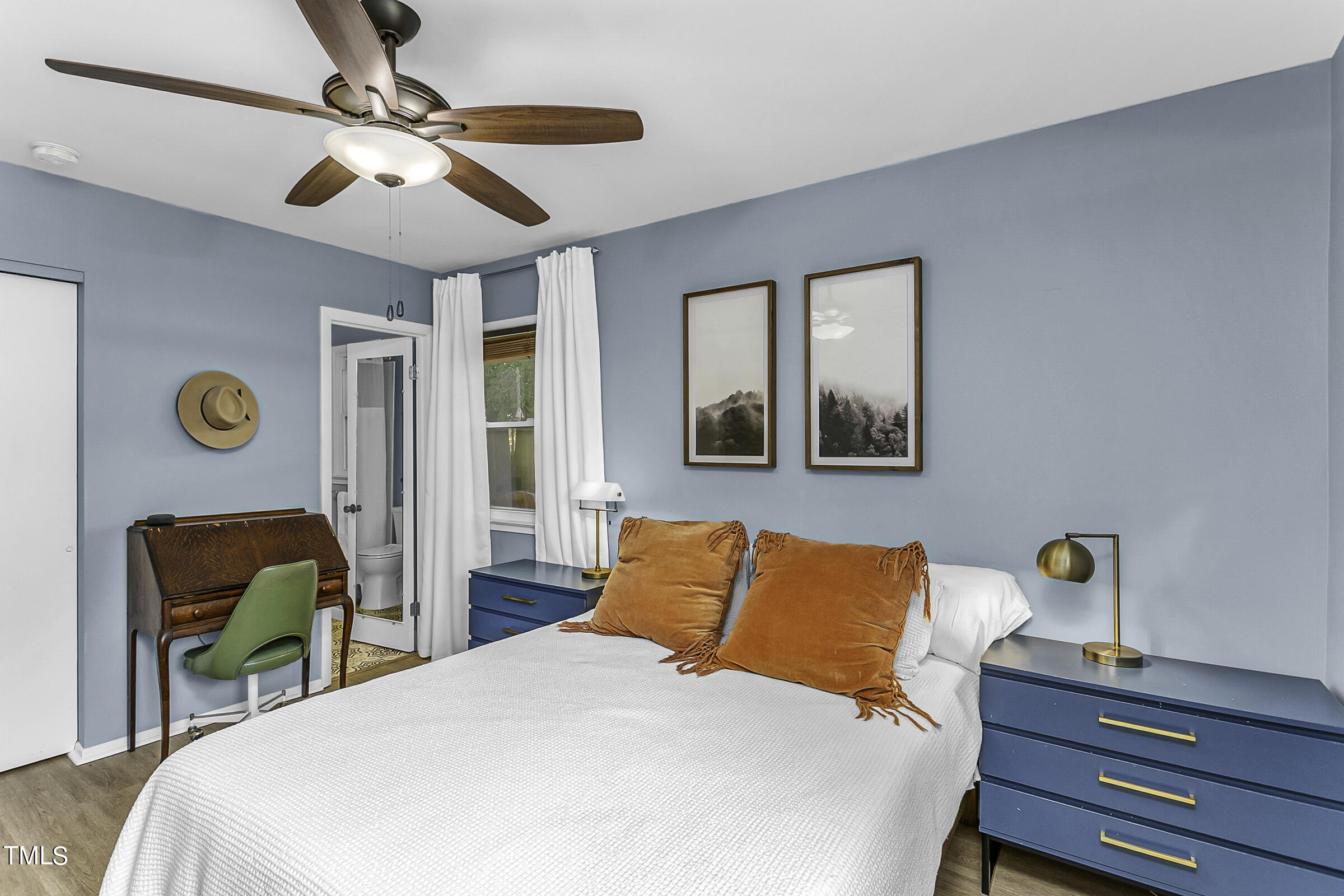 4120 Toroella Street Durham, NC 27704 - Photo 15 of 21 a bedroom with a bed and a chandelier