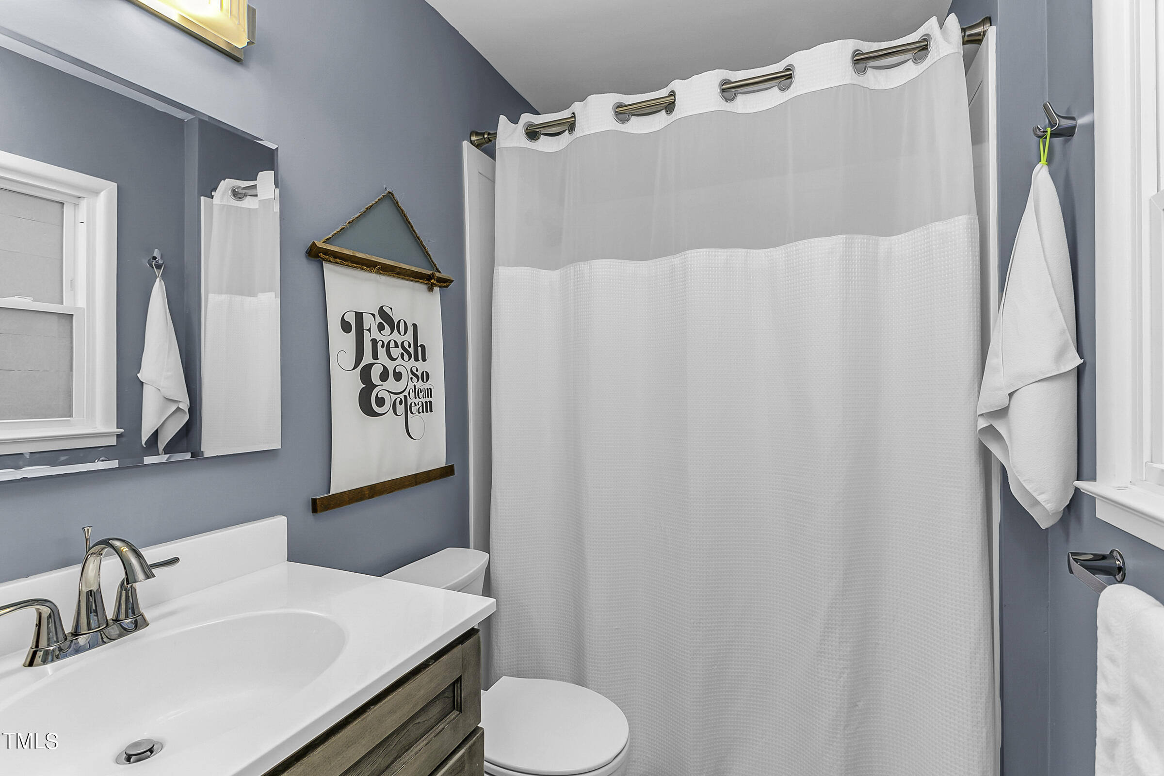 4120 Toroella Street Durham, NC 27704 - Photo 20 of 21 a bathroom with a sink toilet and a mirror