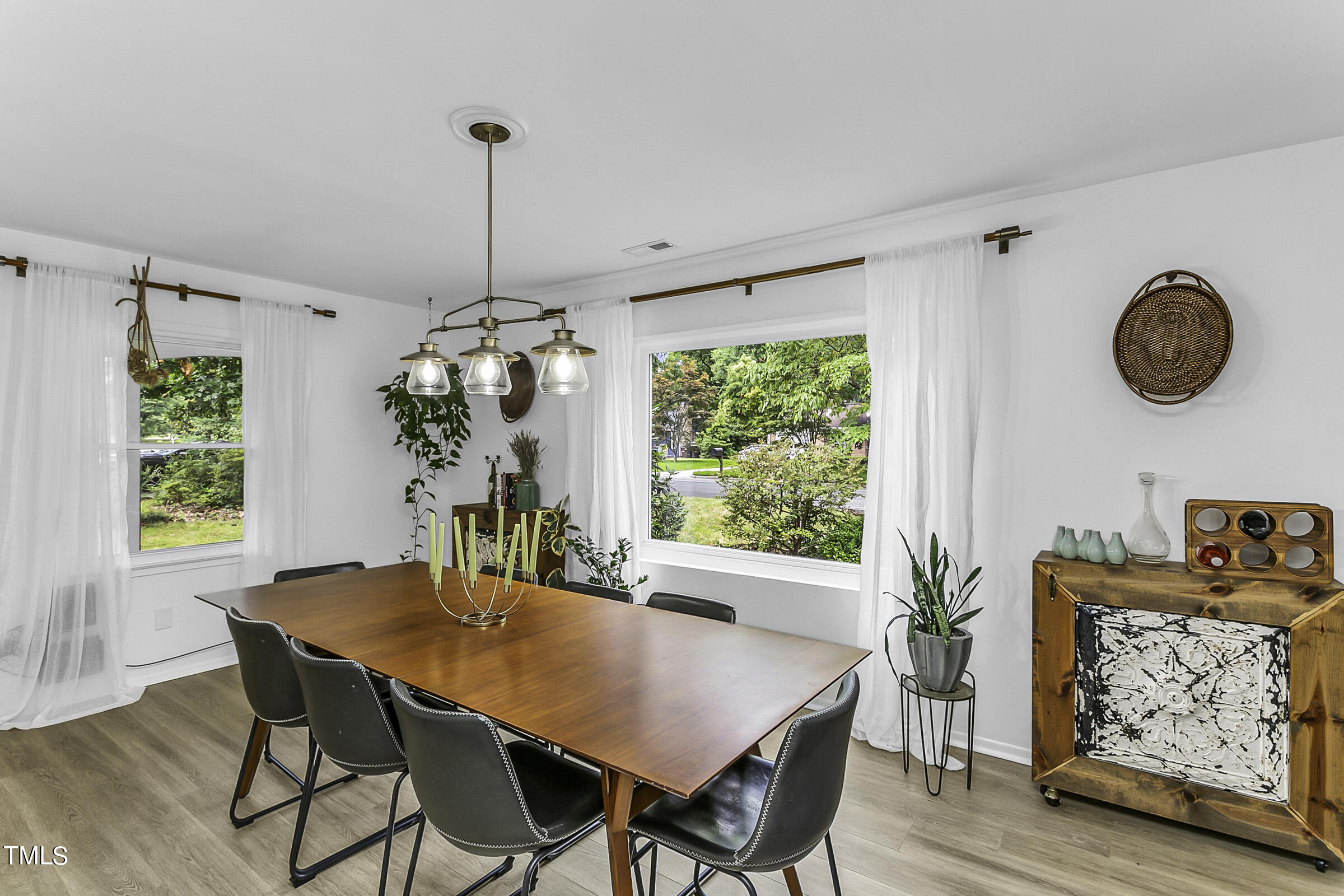 4120 Toroella Street Durham, NC 27704 - Photo 5 of 21 a view of a dining room with furniture window and wooden floor
