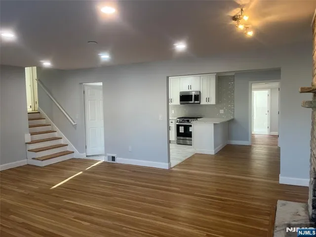 a view of kitchen and hall with wooden floor