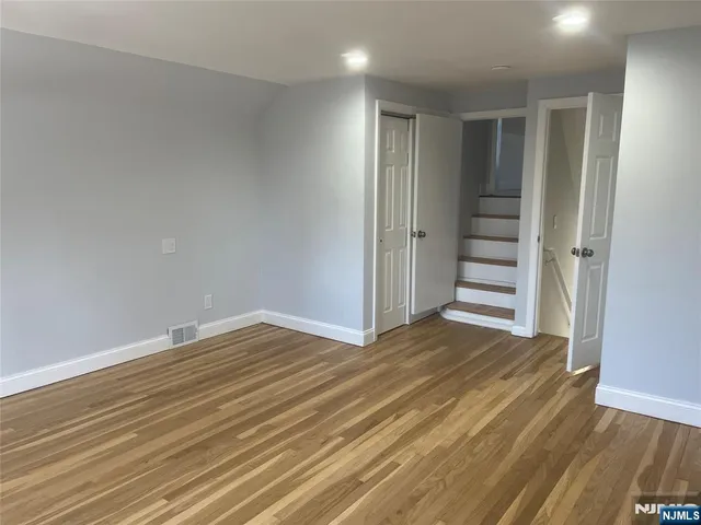 a view of wooden floor and windows in a room