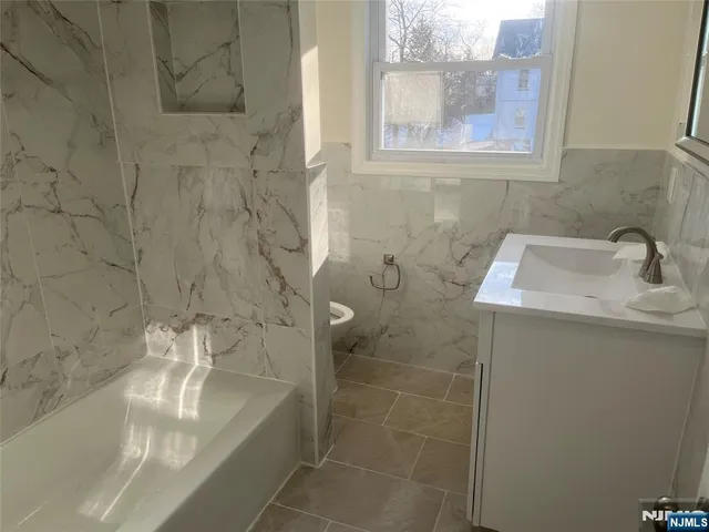 a bathroom with a sink a toilet and a bathtub