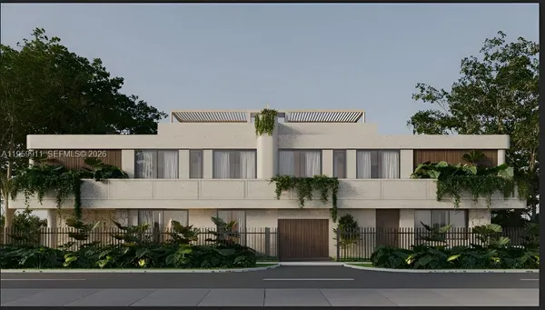 a front view of a house with a yard and potted plants