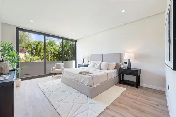 a bedroom with a large bed and a large window