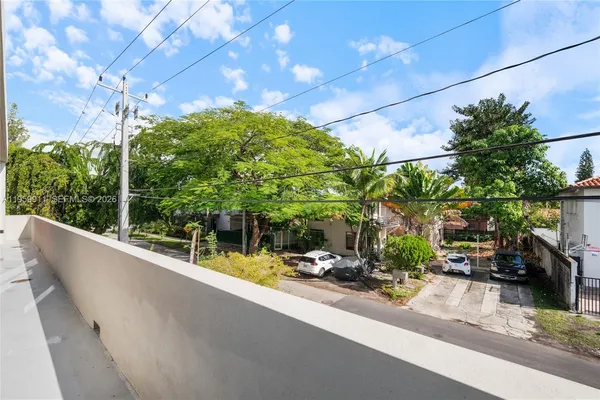 a view of a street with potted plants