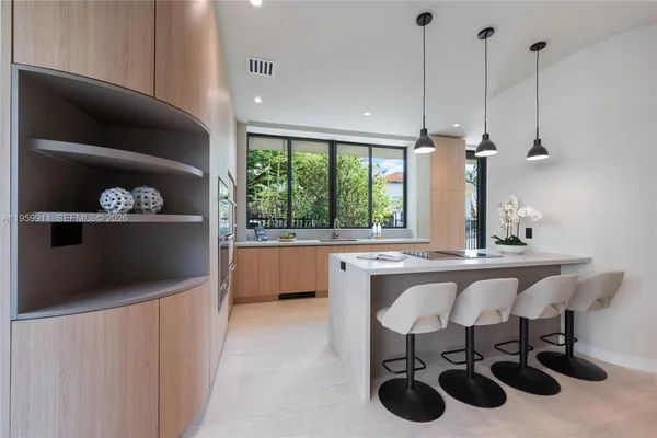 a kitchen with stainless steel appliances a sink a stove and a wooden floor