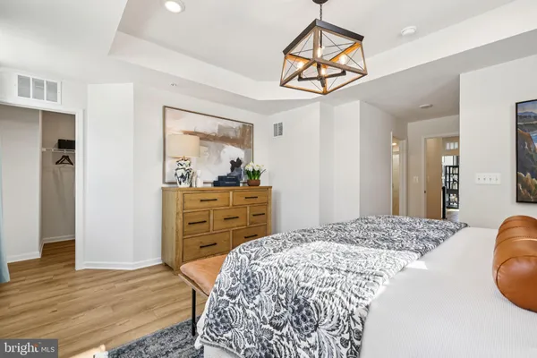 a bedroom with a bed and a dresser in it