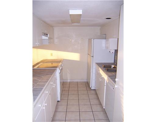 14741 Compass Street, Unit 12 Corpus Christi, TX 78418 - Photo 3 of 6 a kitchen with a sink and a stove top oven