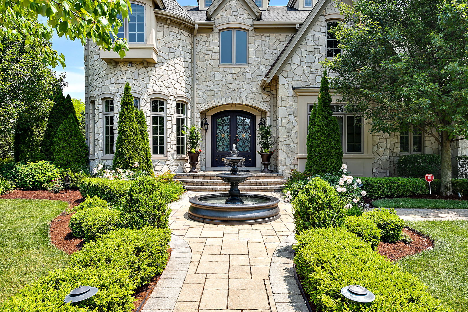 8611 Crest Court Burr Ridge, IL 60527 - Photo 54 of 58 a front view of a house with a garden