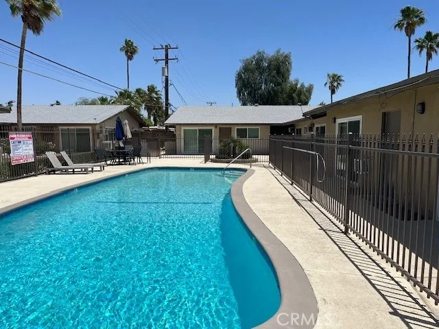 a view of a house with a backyard patio and sitting area