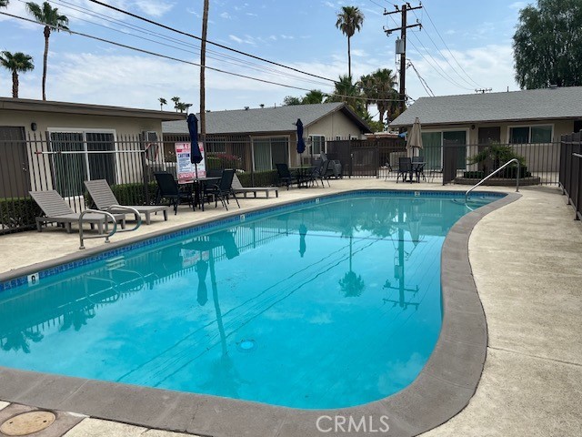 686 East Cottonwood Road, Unit 6 Palm Springs, CA 92262 - Photo 3 of 12 a view of a swimming pool with a patio