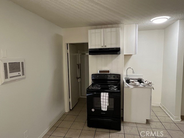 686 East Cottonwood Road, Unit 6 Palm Springs, CA 92262 - Photo 6 of 12 a kitchen with a stove and a refrigerator