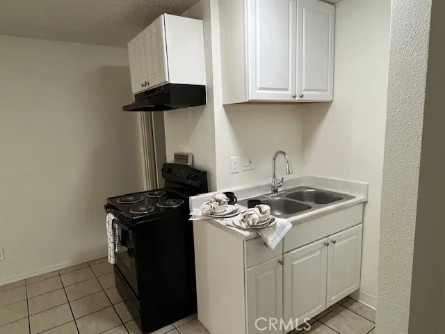 a white stove top oven sitting inside of a kitchen