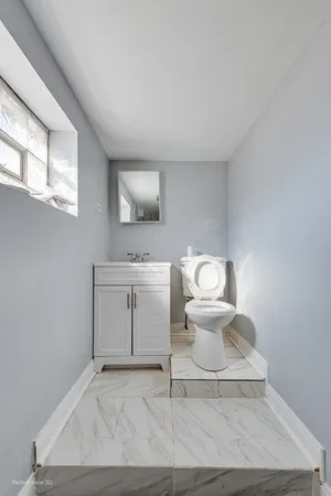 a bathroom with a toilet sink and mirror