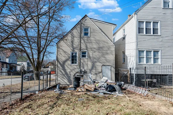 a front view of a house with large tree