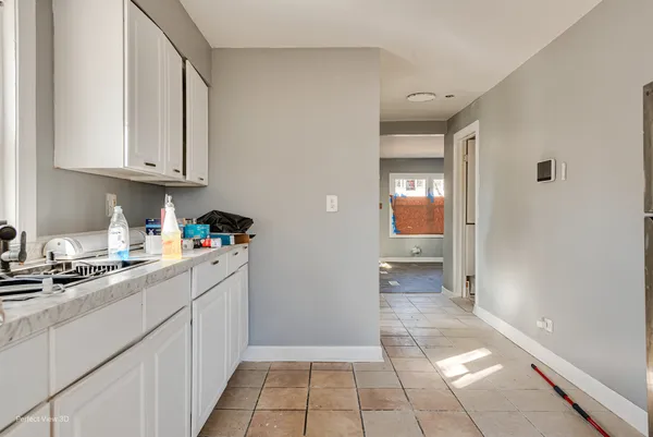 a kitchen with cabinets and window