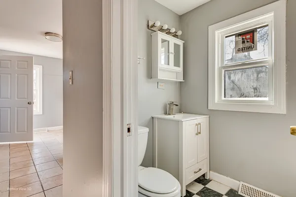a white toilet sitting next to a bathroom sink