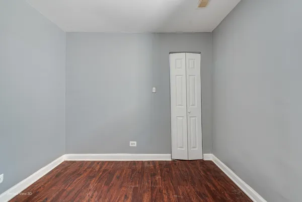 a view of a room with wooden floor and white walls