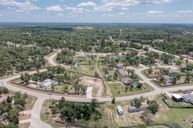 an aerial view of a houses with a yard