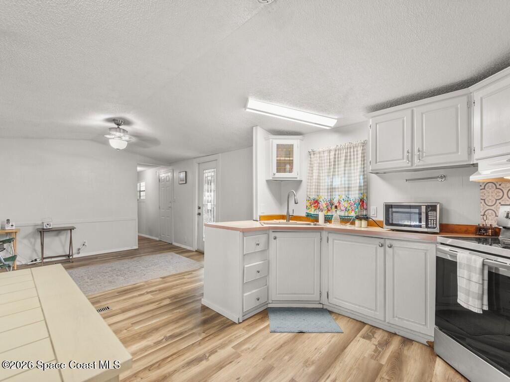 7380 129th Place Sebastian, FL 32958 - Photo 20 of 32 a kitchen with a sink cabinets and window