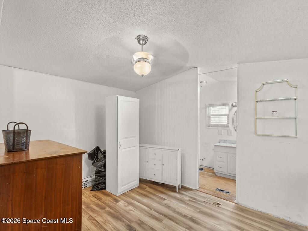 7380 129th Place Sebastian, FL 32958 - Photo 22 of 32 a view of a room with wooden floor and cabinet