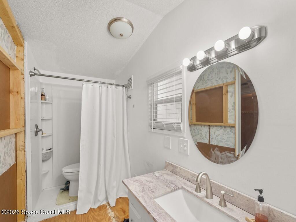 7380 129th Place Sebastian, FL 32958 - Photo 24 of 32 a bathroom with a sink a toilet and a mirror