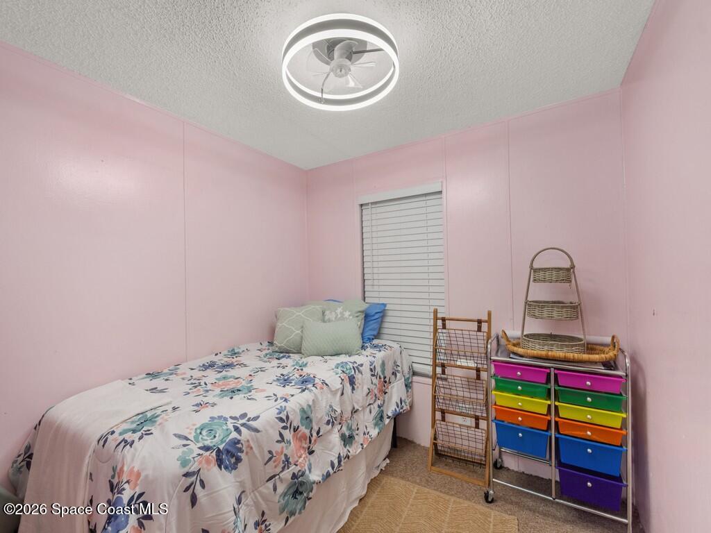 7380 129th Place Sebastian, FL 32958 - Photo 26 of 32 a bedroom with a bed and a wooden floor